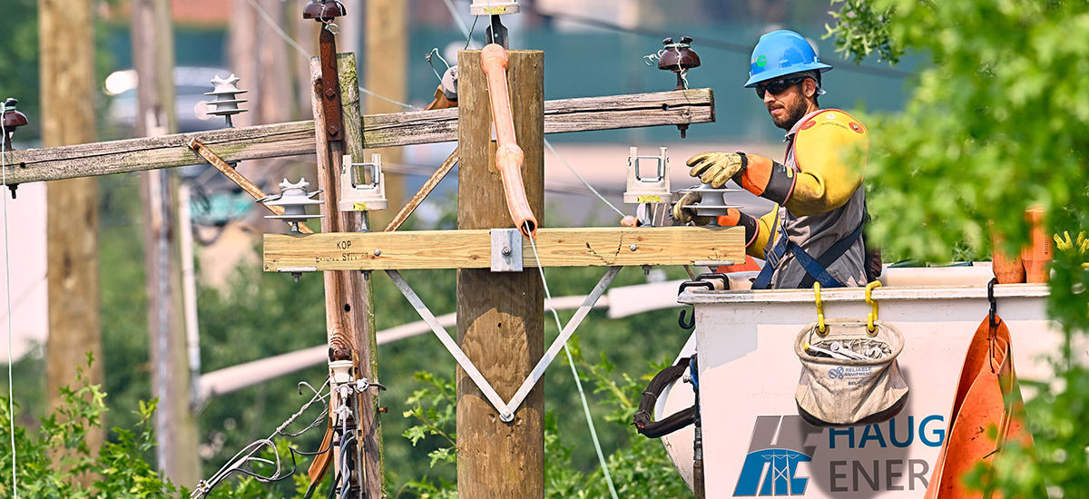 Lineman in a rebranded Haugland Group bucket