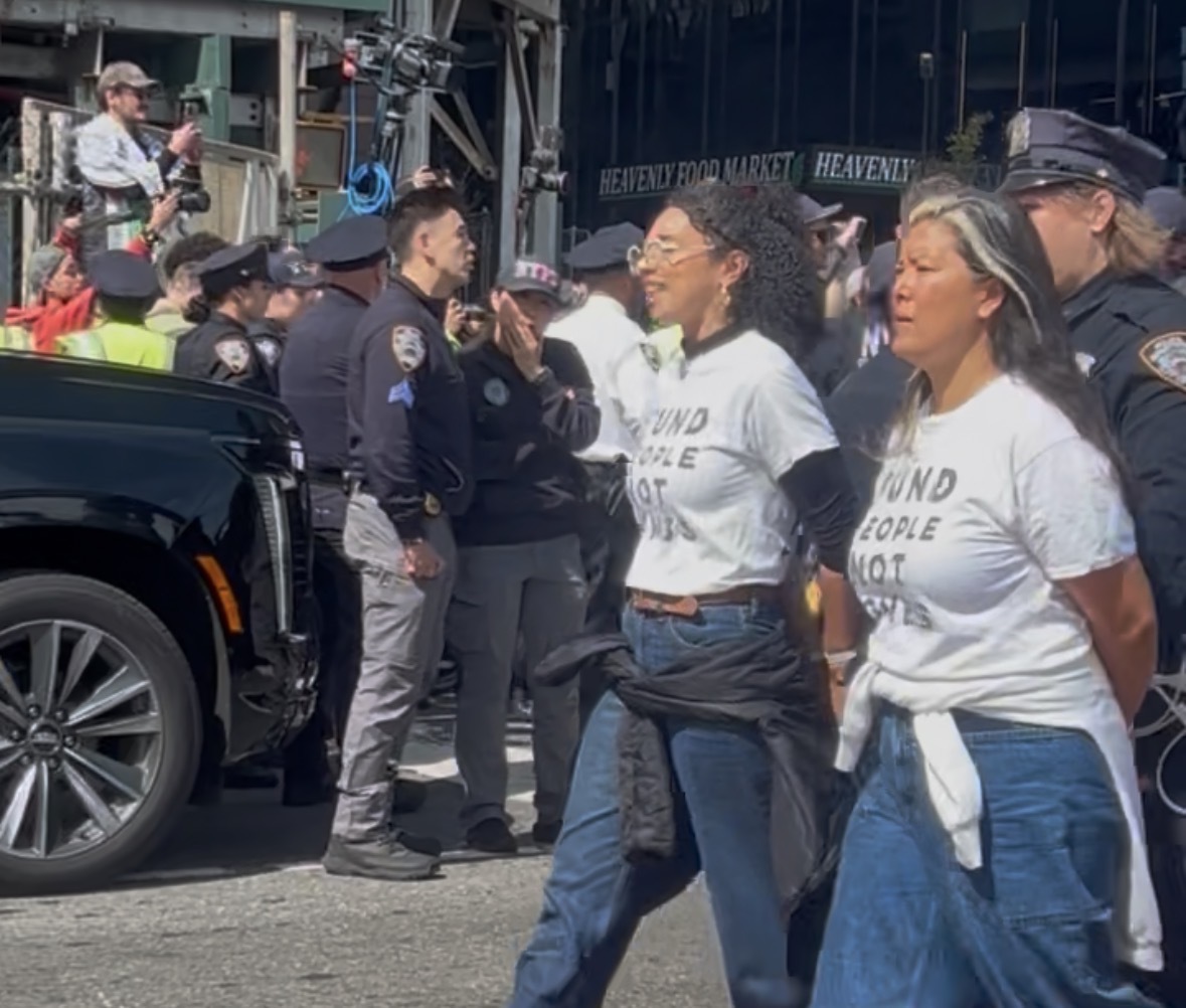 Congressional candidate Darializa Avila Chevalier is led away in cuffs.