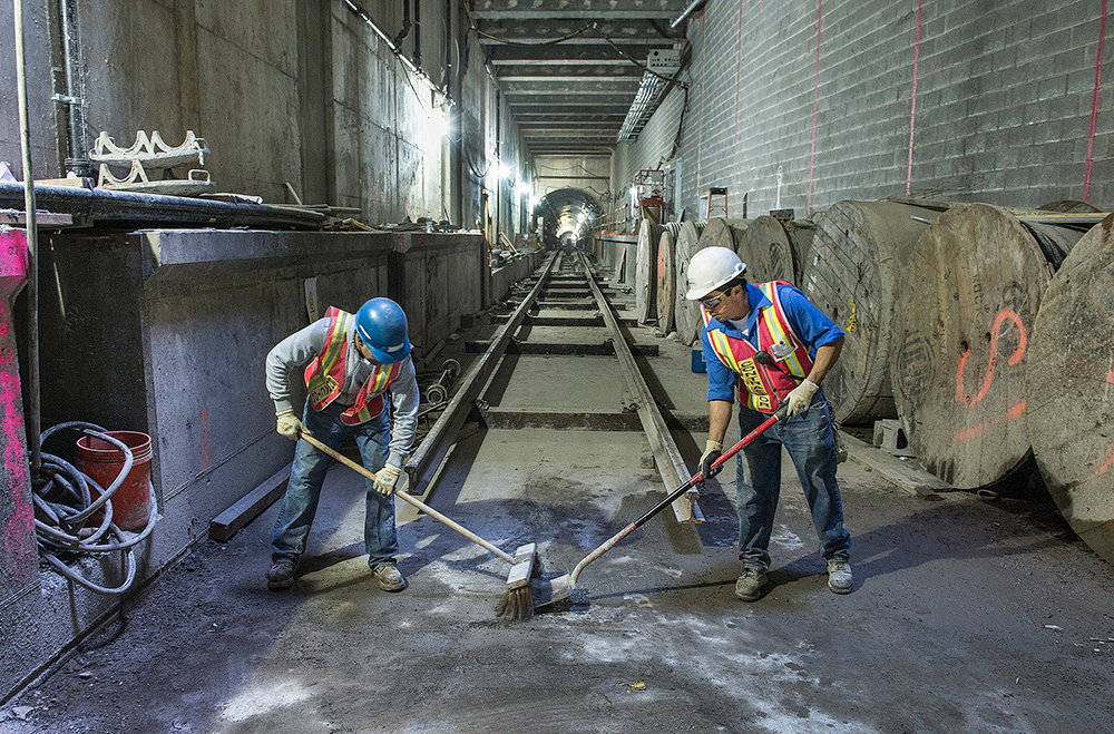 Construction workers on the Second Avenue Subway project. Construction workers sweep at the second avenue subway line
