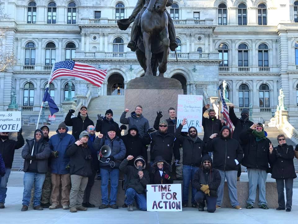 An event that includes a photo of so-called "Three Percenters" flashing a hand gesture that has been linked with white supremacist groups has been posted on a Facebook group promoting opposition to new criminal justice reforms.