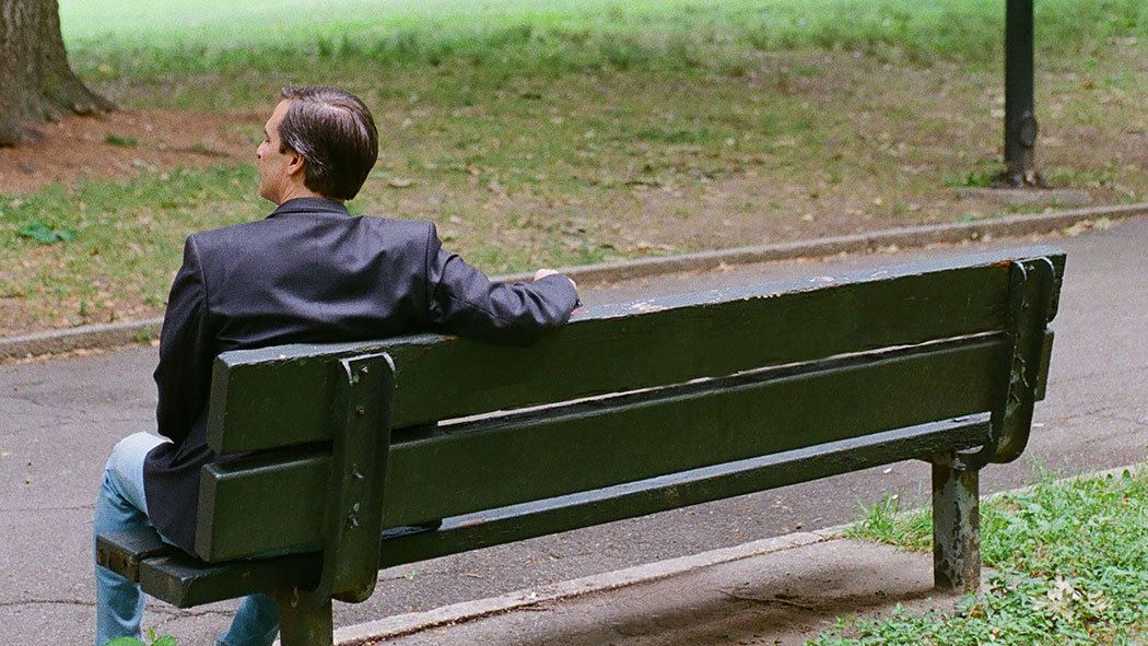 Gianaris sits on a park bench in Queens.