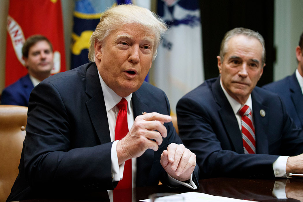 Rep. Chris Collins listens as President Donald Trump speaks during a meeting with members of Congress.