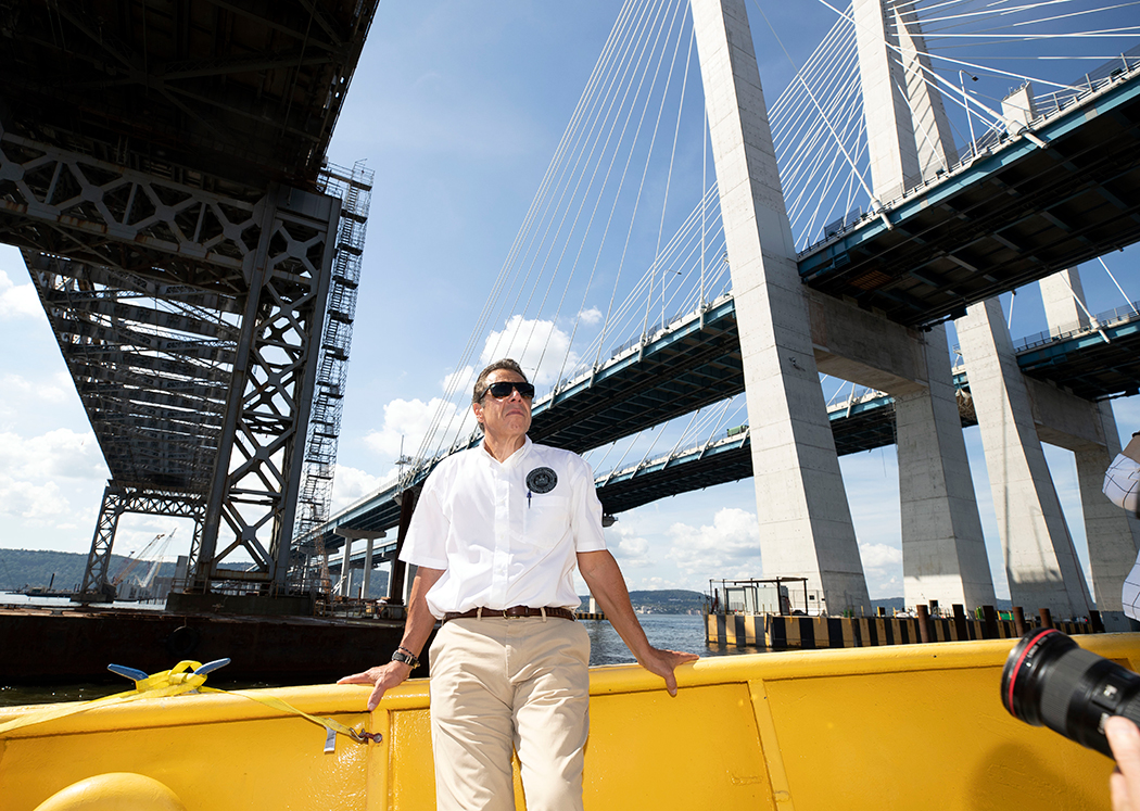 Andrew Cuomo standing in front of the Mario Cuomo Bridge