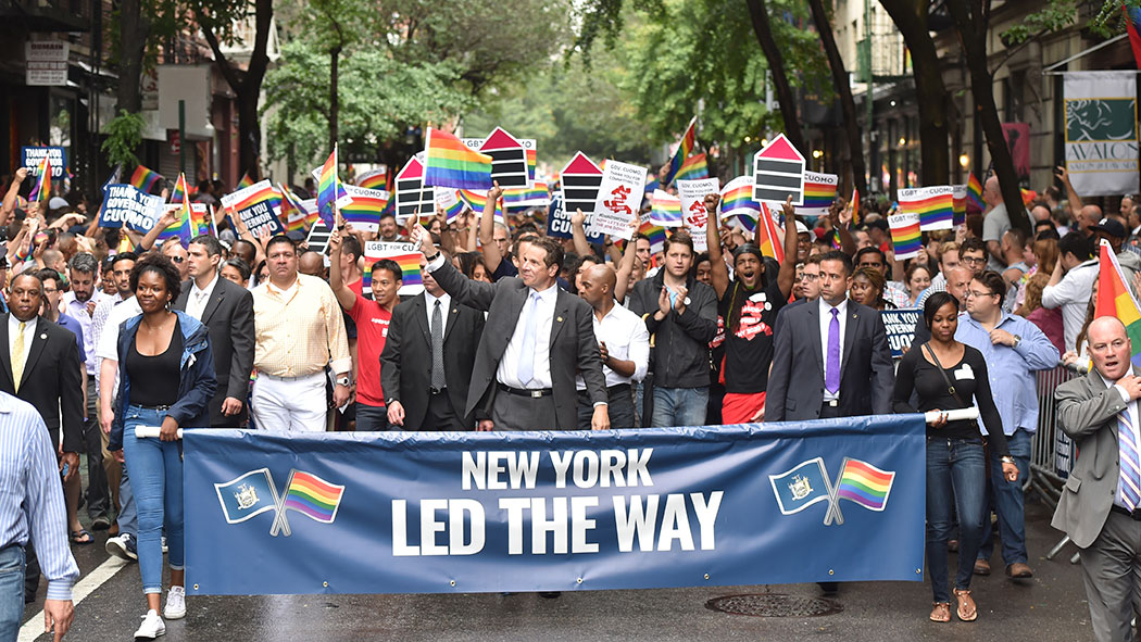 Gov. Andrew Cuomo smiles and waves in the 2015 New York City Pride.