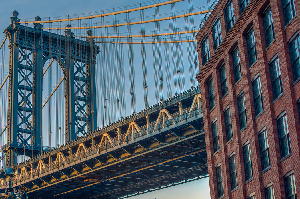 View of one of the towers of the Manhattan Bridge from the streets of the DUMBO district, Brooklyn, NYC