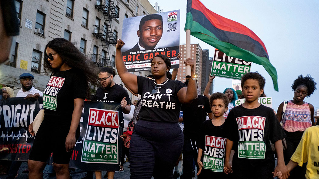 Black Lives Matter activists protest in Harlem, in the wake of a decision by federal prosecutors who declined to bring civil rights charges against NYPD officer Daniel Pantaleo. 