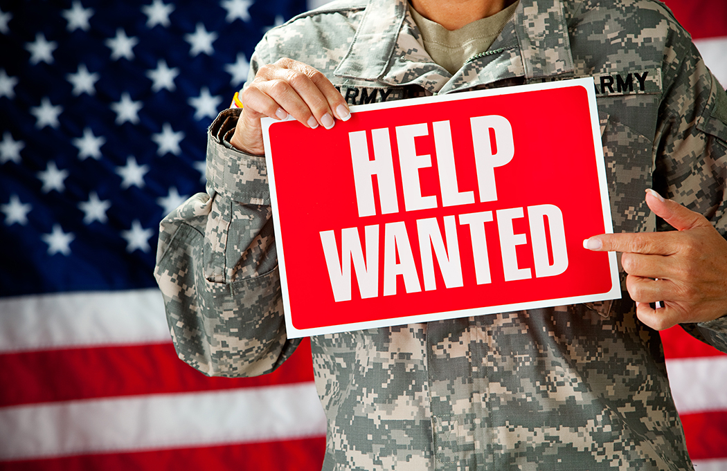 Soldier holding a help wanted sign Soldier holding a help wanted sign
