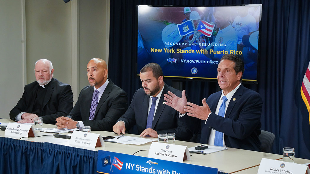 Monsignor Kevin Sullivan, executive director of Catholic Charities of the Archdiocese of New York, Bronx Borough President Ruben Diaz, Jr, Assemblyman Marcos Crespo and Gov. Andrew M. Cuomo announce $2 million to support more than 11,000 displaced Hurrica