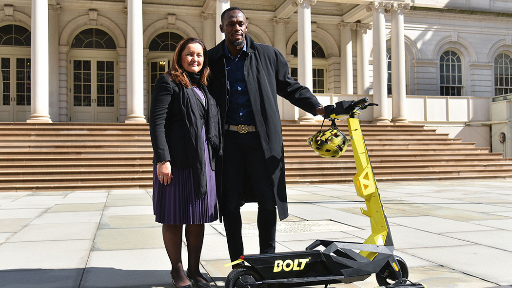 Dr. Sarah Haynes, Chairwoman and Co-founder of Bolt Mobility and Usain Bolt unveiling Bolt Personal Electric Scooters on the steps of New York City Hall in March.