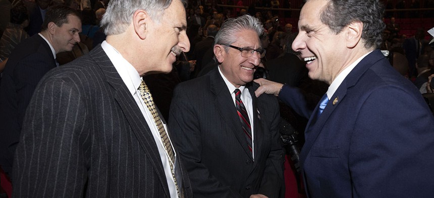 Gov. Andrew Cuomo laughing with Assemblyman David Weprin and state Sen. James Tedisco at his joint State of the State and budget address.
