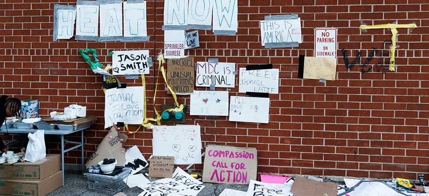 signs facing the Metropolitan Detention Center (MDC), a federal prison used mostly for pre-trial detention, in Brooklyn, New York