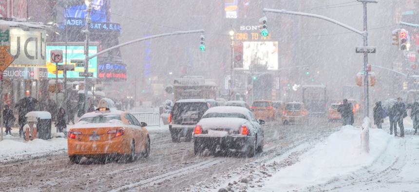 Image of a snowy street in NYC during a blizzard.