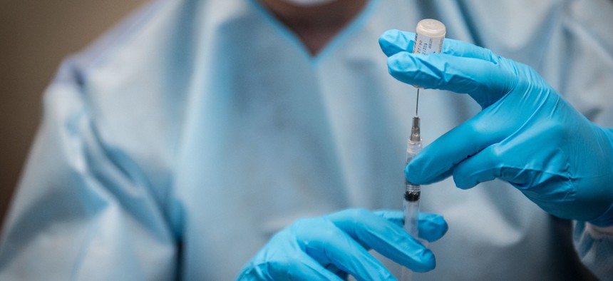 A COVID-19 vaccine is administered at NYC Health + Hospitals/Elmhurst in Queens.