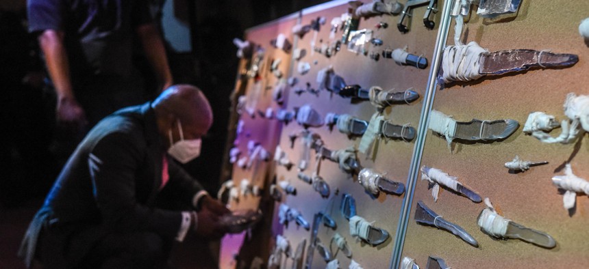 Eric Adams with a display of weapons confiscated from those in custody on Rikers Island.