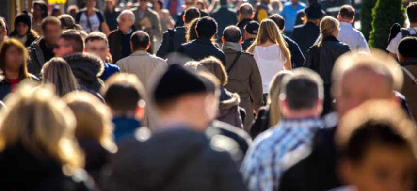 People on a crowded sidewalk in New York City.
