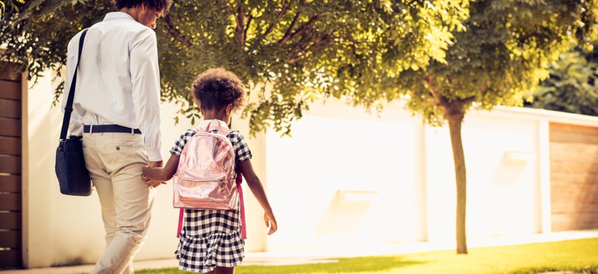 An adult walking with a child