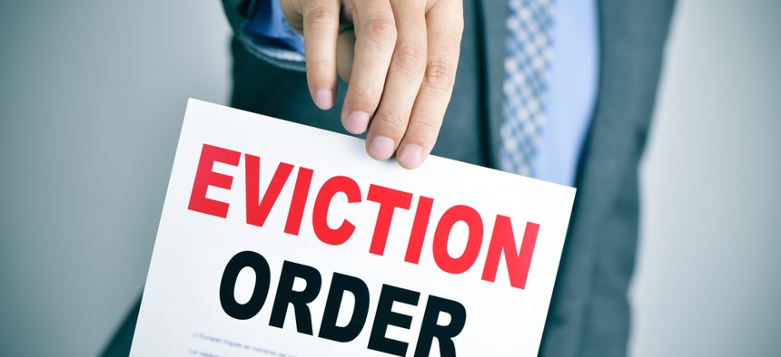 Photo of an eviction notice being delivered