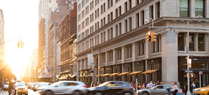 Cars speed down 5th Avenue in Manhattan.