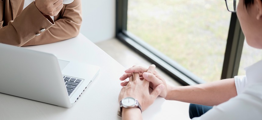 Two people meeting across a table.