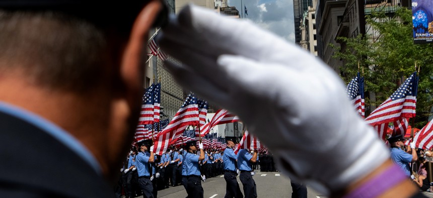 Members of the New York Fire Department carry American flags during the FDNY Memorial Service at St. Patrick's Cathedral on September 11, 2021 in New York City.