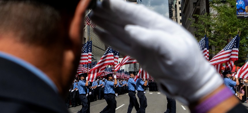 Members of the New York Fire Department carry American flags during the FDNY Memorial Service at St. Patrick's Cathedral on September 11, 2021 in New York City.