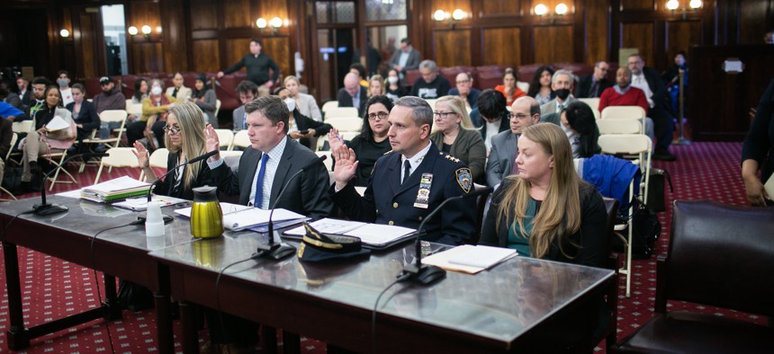 NYPD Director of Legislative Affairs Michael Clarke (second from left) testifies at a City Council hearing on March 27, 2023.