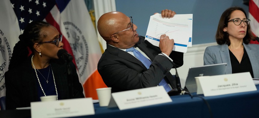 City Budget Director Jacques Jiha, center, has called on city agencies to make significant spending cuts.