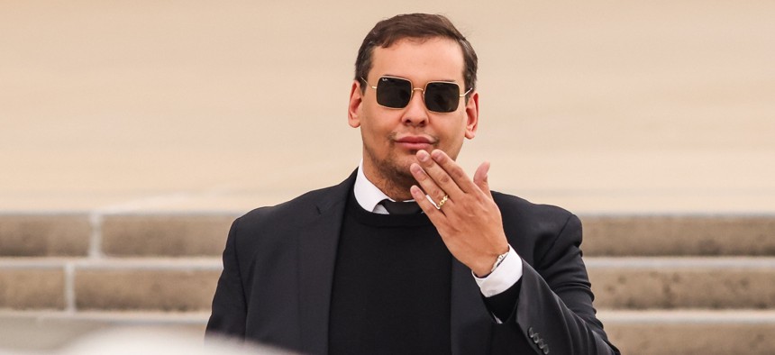 Rep. George Santos blows a kiss as he exits a Long Island federal courthouse. 