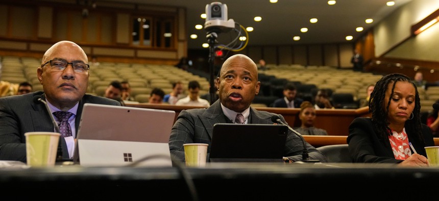 From left, city Budget Director Jacques Jiha, Mayor Eric Adams and Deputy Mayor Sheena Wright testify before lawmakers in 2023.