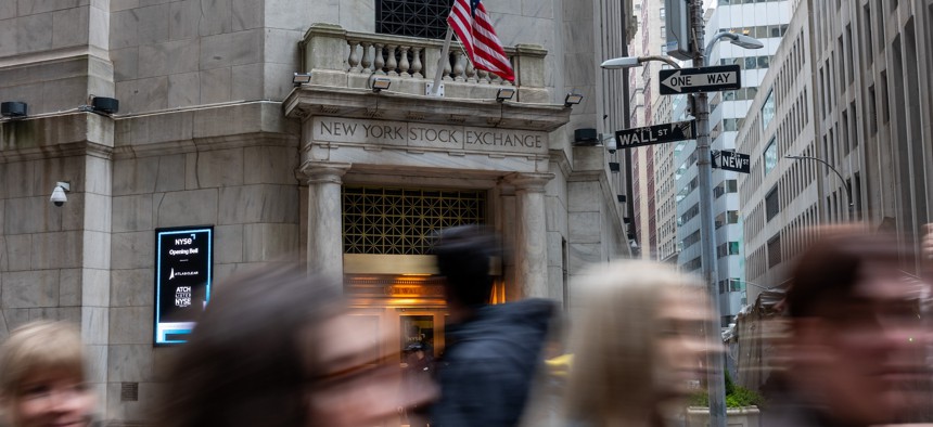 People walk outside the New York Stock Exchange on March 6, 2024.