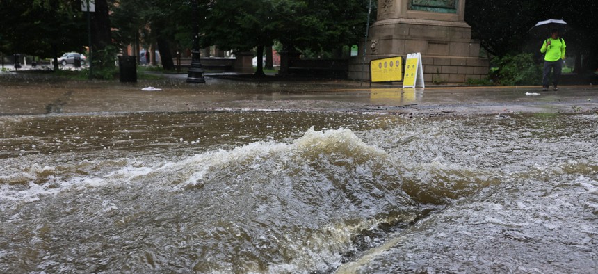 Water gushes into a storm drain near Prospect Park as remnants of Tropical Storm Ophelia soak New York City in September 2023.
