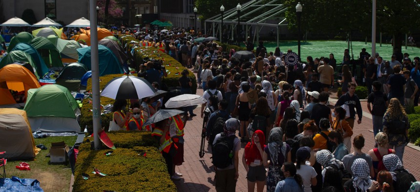 Columbia University students and faculty members walk in a picket line around the Gaza Solidarity Encampment on April 29, 2024.