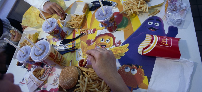 Grimace, right, waves from a placemat.