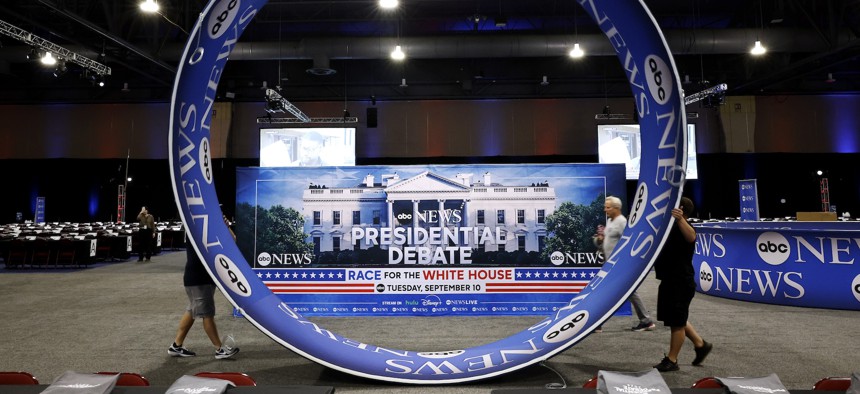 Workers prepare signage in advance of Tuesday night's presidential debate in Philadelphia.