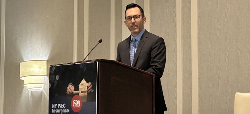 Travis Wattie, assistant vice president of government relations at Big I New York, delivers remarks at the New York P&C Insurance Summit in Albany Tuesday.