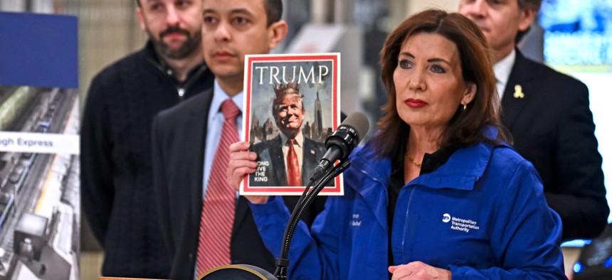 Gov. Kathy Hochul holds a mock version of Time magazine’s “Person of the Year” issue, proclaiming Donald Trump a “king," during a press conference at Grand Central Terminal Wednesday.