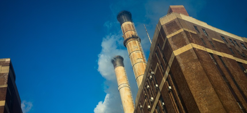 Smoke and condensation flow from smokestacks at a power plant in Manhattan.
