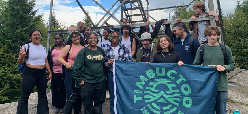 Students pose at the top of Goodnow Mountain on the SUNY College of Environmental Science and Forestry’s Newcomb Campus.