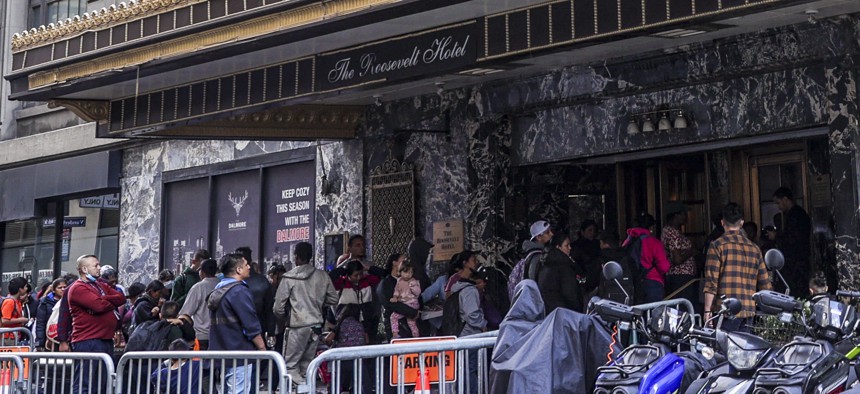 Asylum-seekers arrive to the Roosevelt Hotel in Midtown Manhattan in 2023.