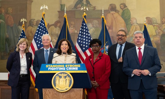 Flanked by District Attorneys Melinda Katz, Michael McMahon, Darcel Clark, Alvin Bragg and Eric Gonzalez, Gov. Kathy Hochul announces changes to the discovery law on May 7, 2025. Credit: Office of Governor Kathy Hochul