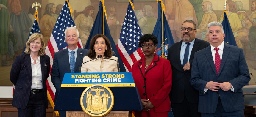 Flanked by District Attorneys Melinda Katz, Michael McMahon, Darcel Clark, Alvin Bragg and Eric Gonzalez, Gov. Kathy Hochul announces changes to the discovery law on May 7, 2025. Credit: Office of Governor Kathy Hochul