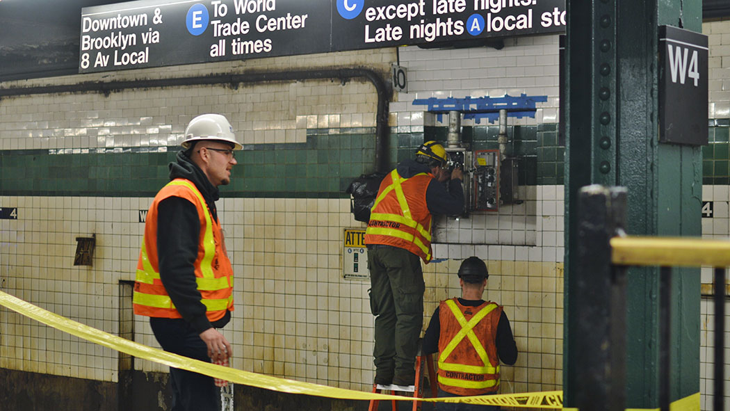 MTA employees at work. MTA employees at work.
