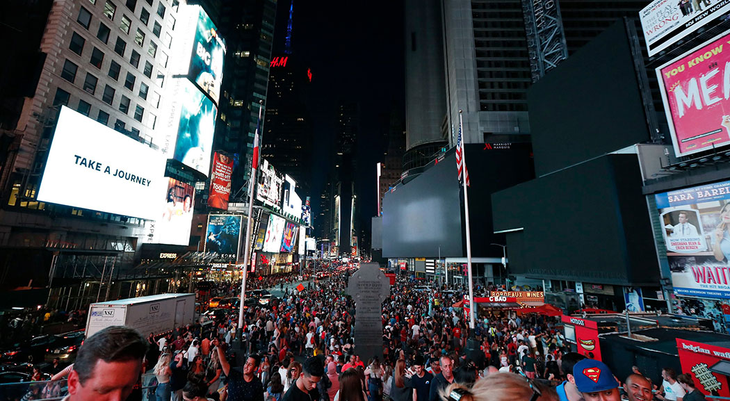 Screens in Times Square went black during a power outage in New York City on Saturday. Screens in Times Square went black during a power outage in New York City on Saturday.
